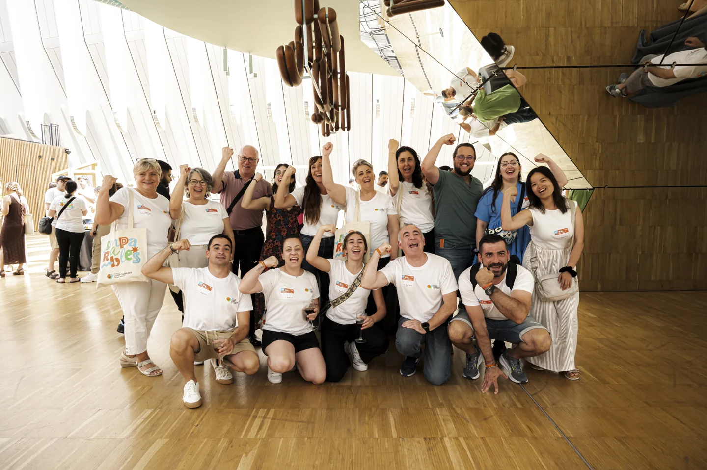 Grupo de personas con camisetas blancas posando en una sala